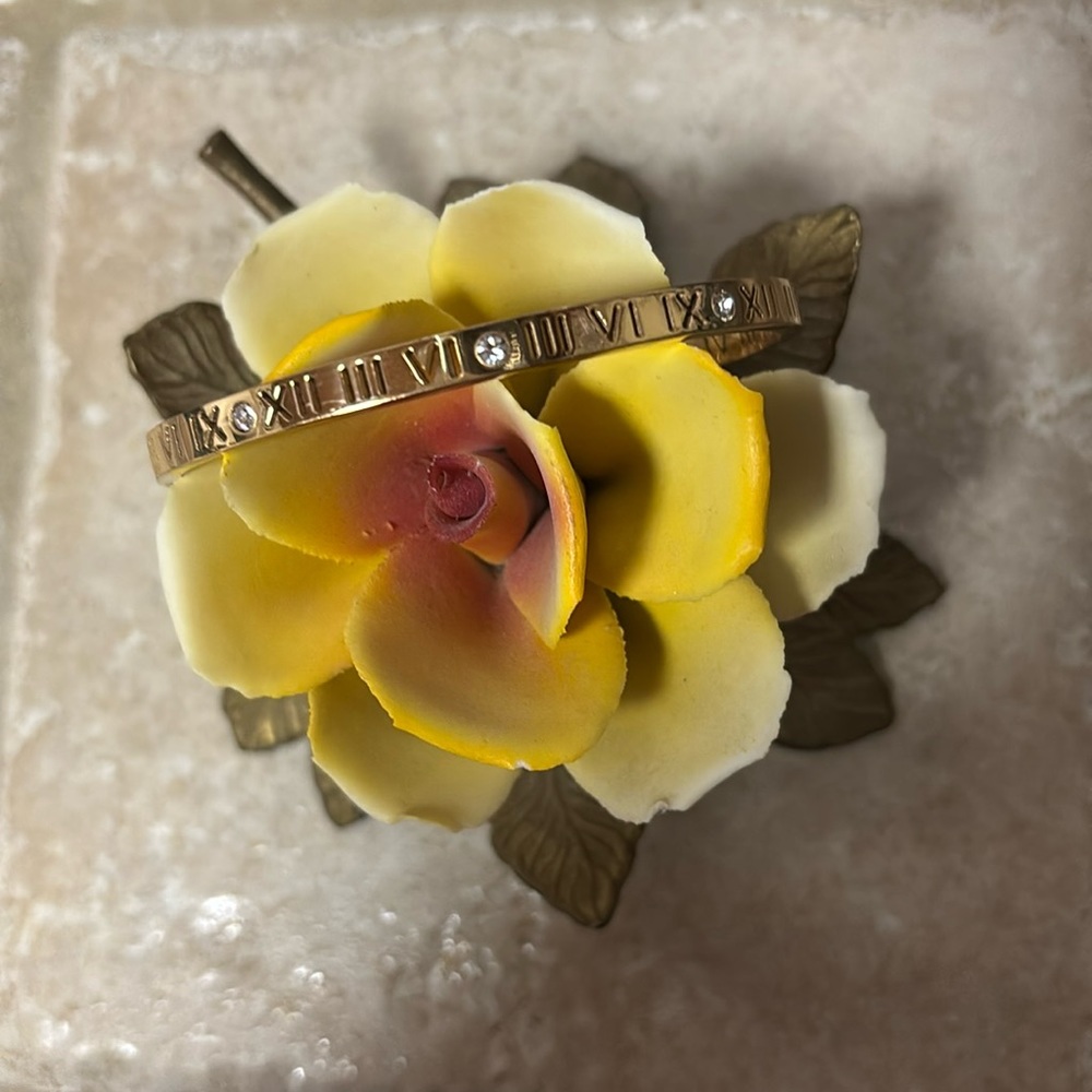 Roman numeral and faux crystal design bangle bracelet.